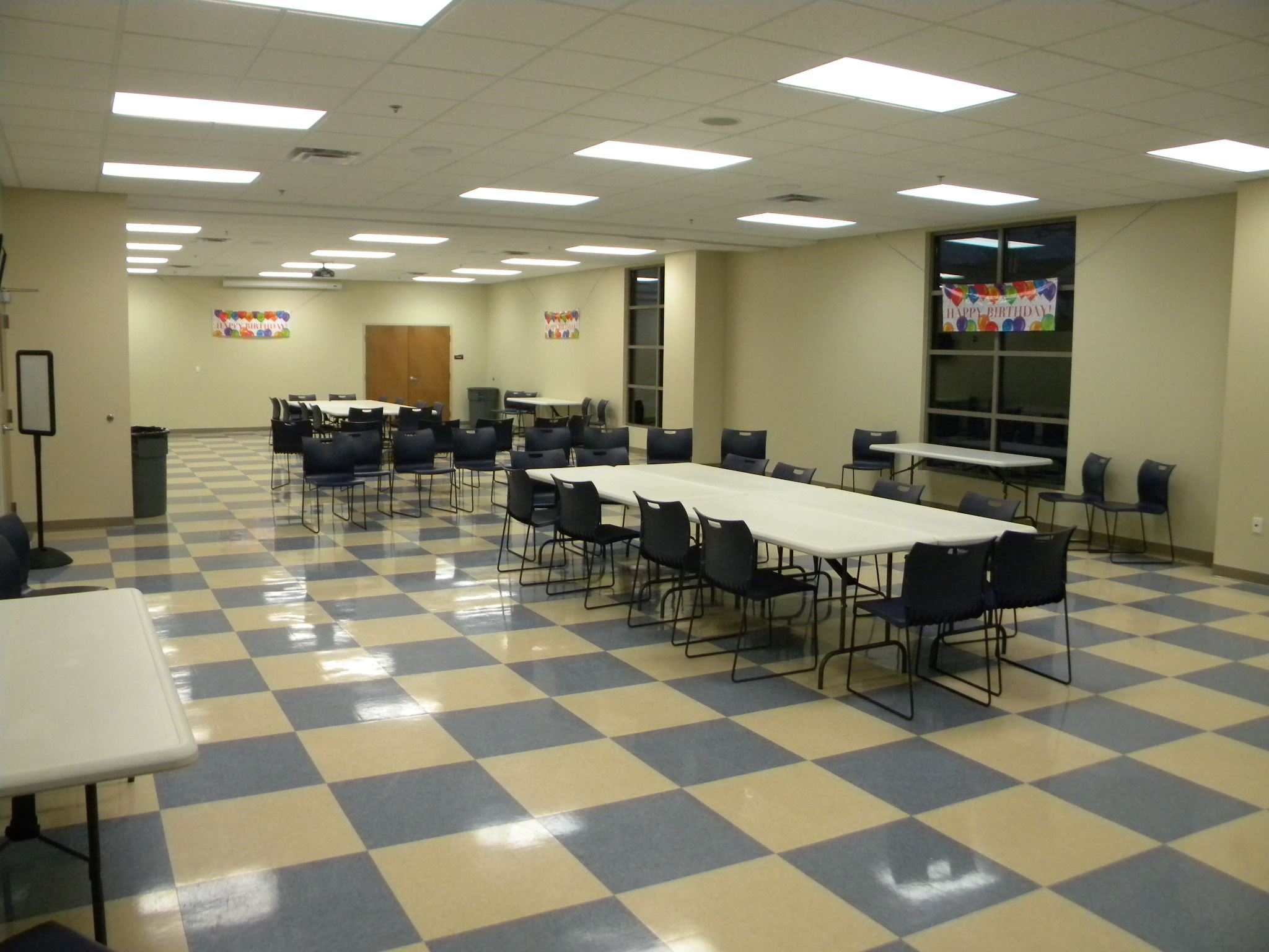 A large room set up with tables and chairs.